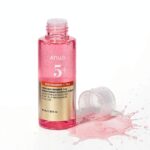 Anua Niacinamide 5 TXA Brightening Booster Toner bottle with pink toner splash on white background